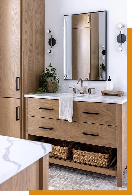 Bathroom vanity with natural wood cabinets and a stone top
