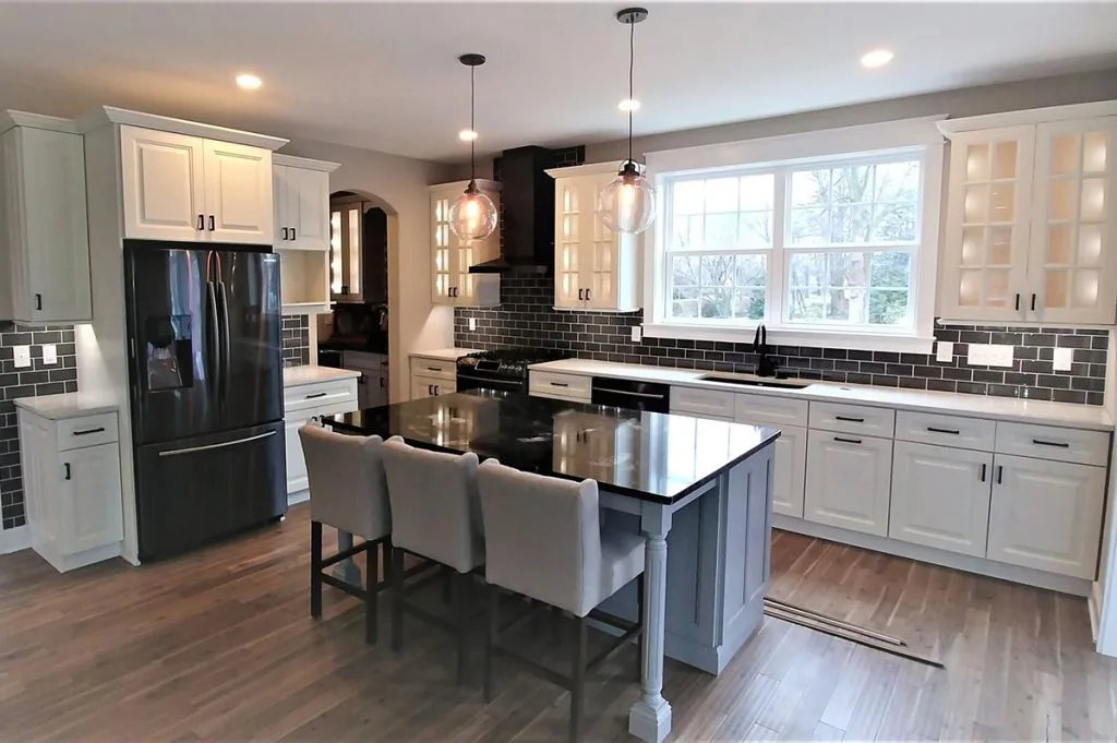 White inset kitchen cabinets with a marble-look countertop